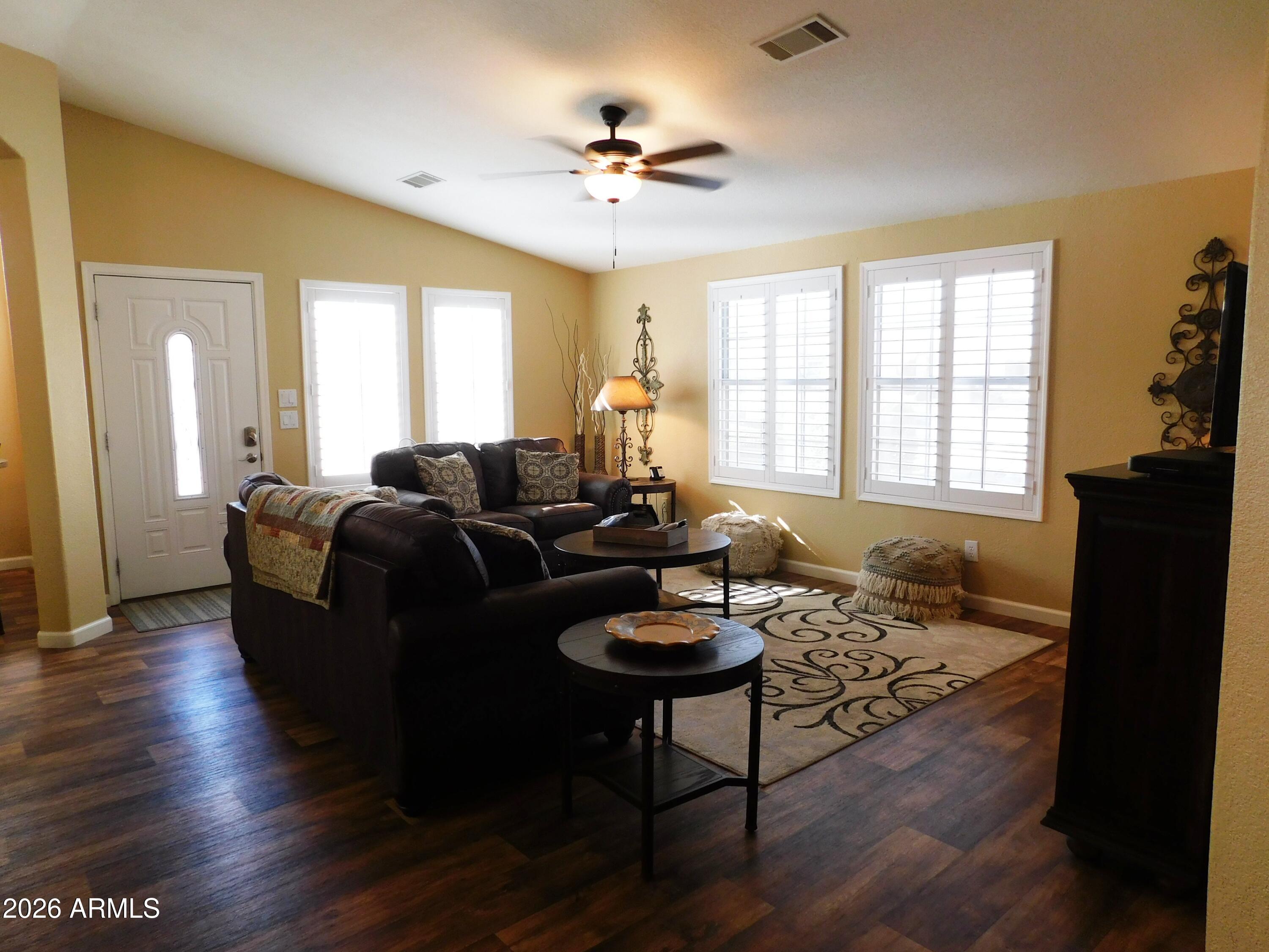 3301 South Goldfield Road, Unit 1054 Apache Junction, AZ 85119 - Photo 13 of 41 a living room with furniture and a window
