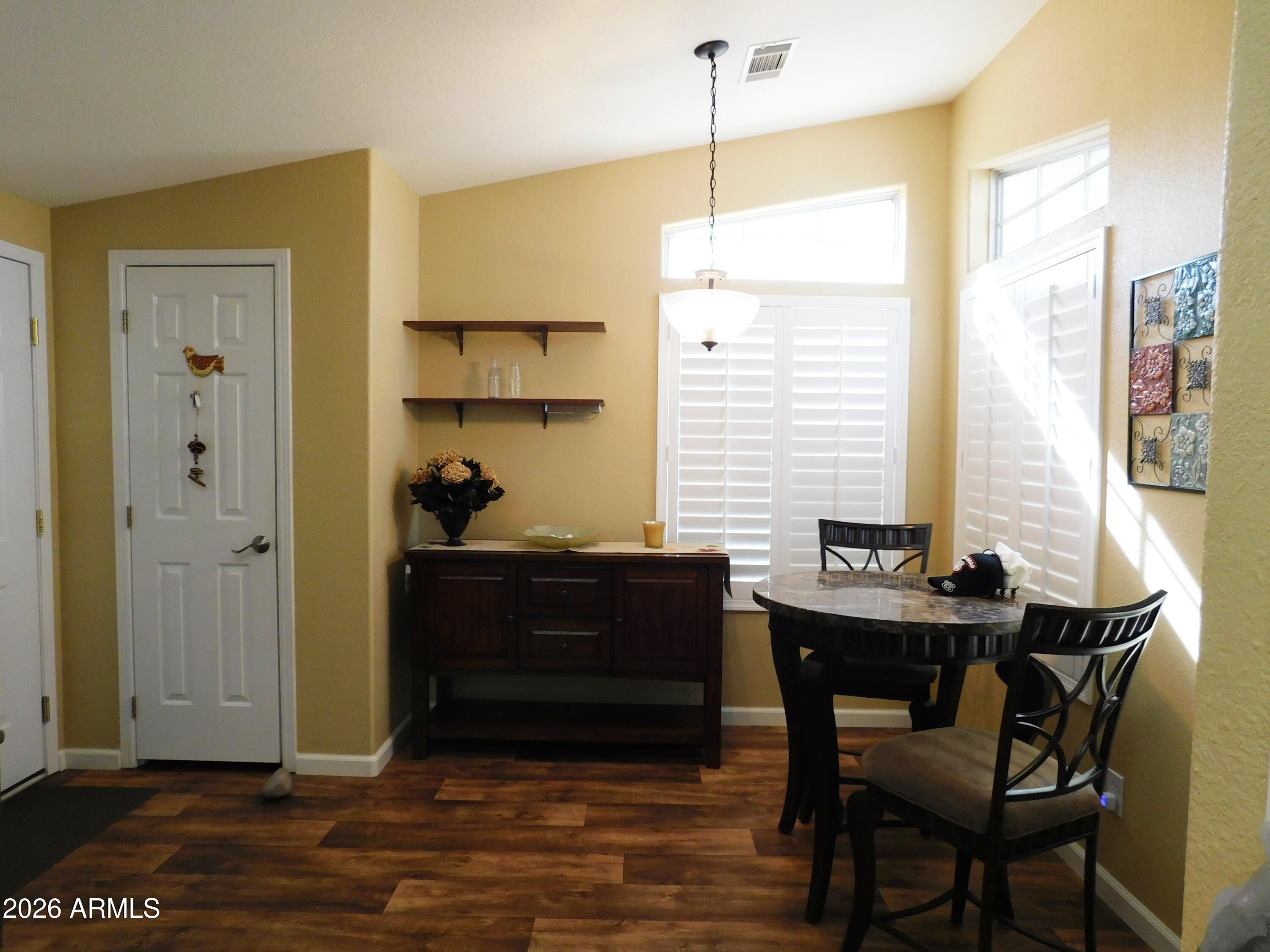 3301 South Goldfield Road, Unit 1054 Apache Junction, AZ 85119 - Photo 14 of 41 a view of a dining room with furniture and window