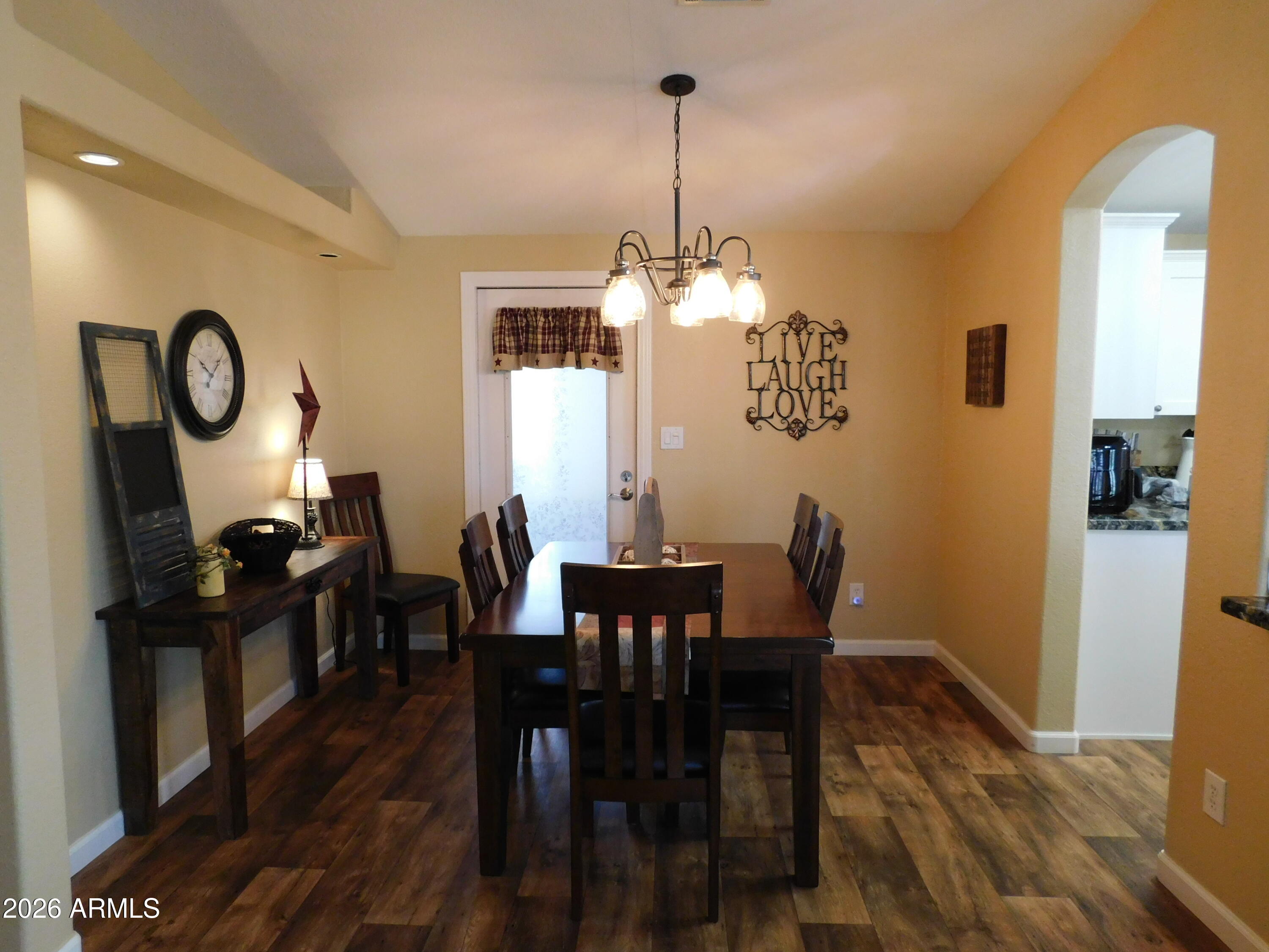 3301 South Goldfield Road, Unit 1054 Apache Junction, AZ 85119 - Photo 17 of 41 a view of a dining room with furniture window and wooden floor
