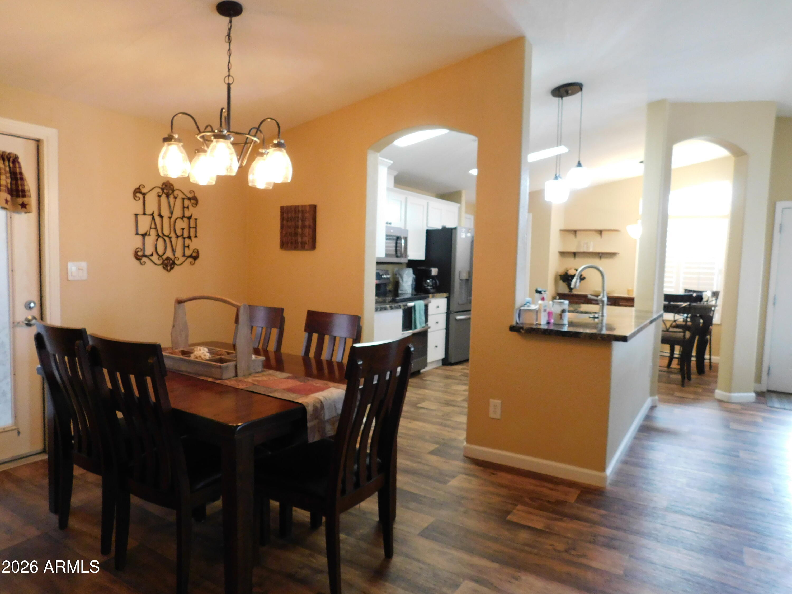 3301 South Goldfield Road, Unit 1054 Apache Junction, AZ 85119 - Photo 19 of 41 a view of a dining room with furniture window and wooden floor