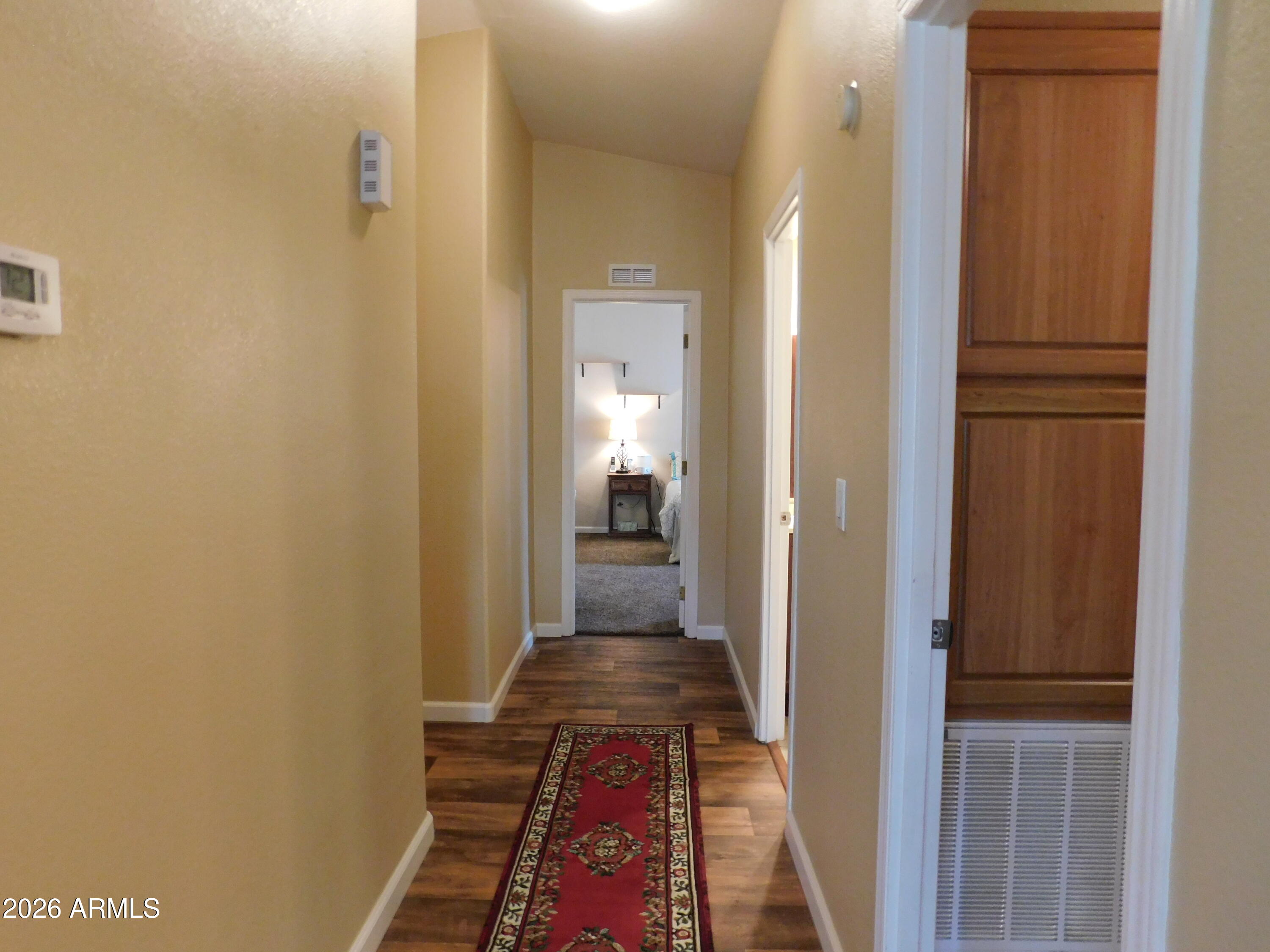 3301 South Goldfield Road, Unit 1054 Apache Junction, AZ 85119 - Photo 22 of 41 a view of a hallway with a livingroom and a bathroom with sink