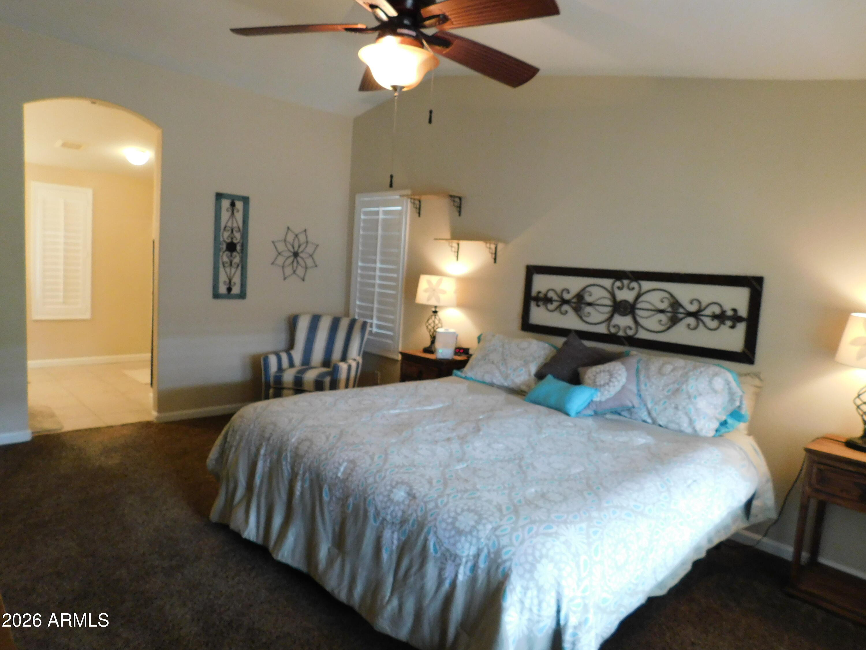 3301 South Goldfield Road, Unit 1054 Apache Junction, AZ 85119 - Photo 27 of 41 a bedroom with a bed and window