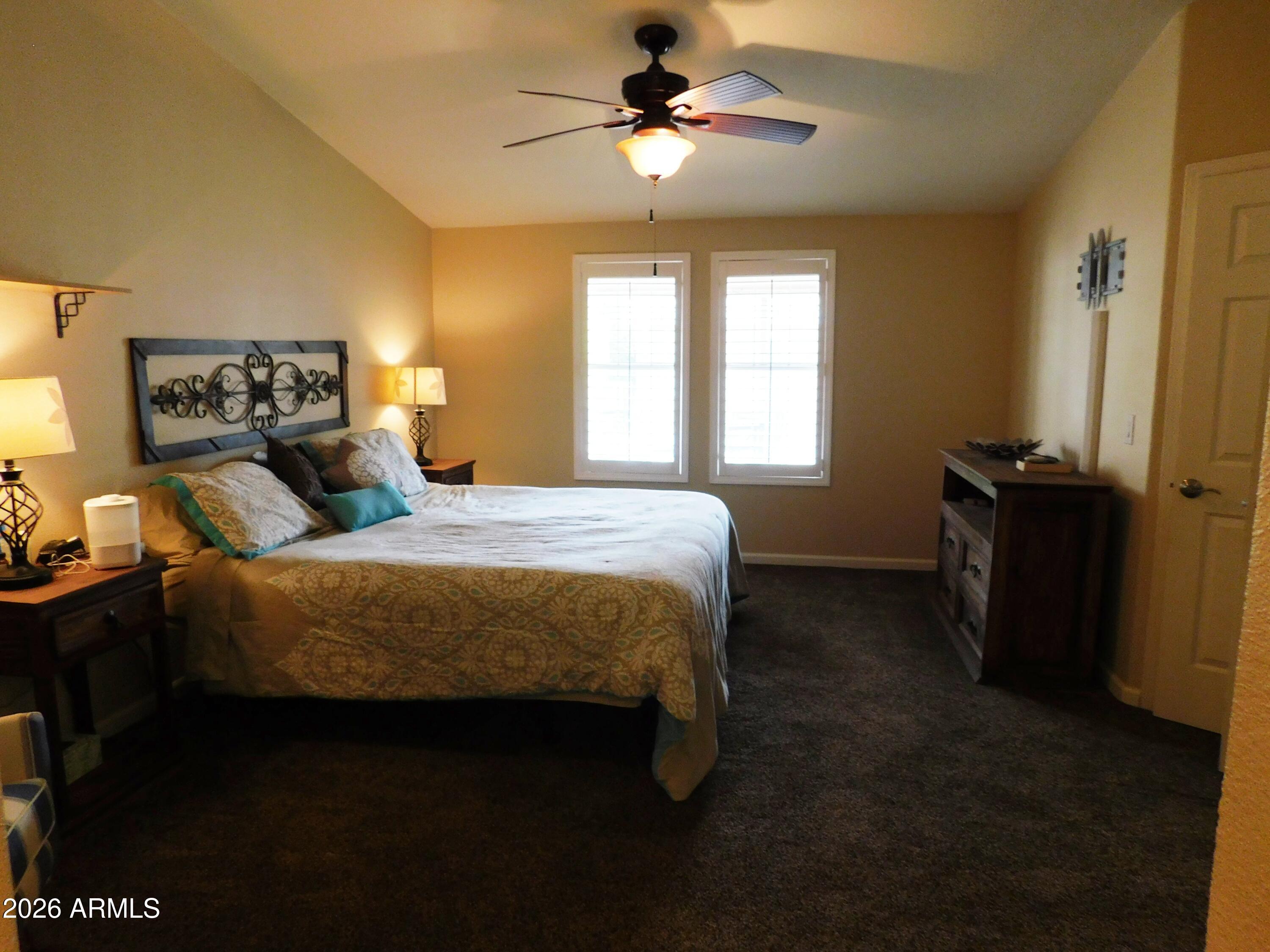 3301 South Goldfield Road, Unit 1054 Apache Junction, AZ 85119 - Photo 30 of 41 a bedroom with a bed dresser and a window