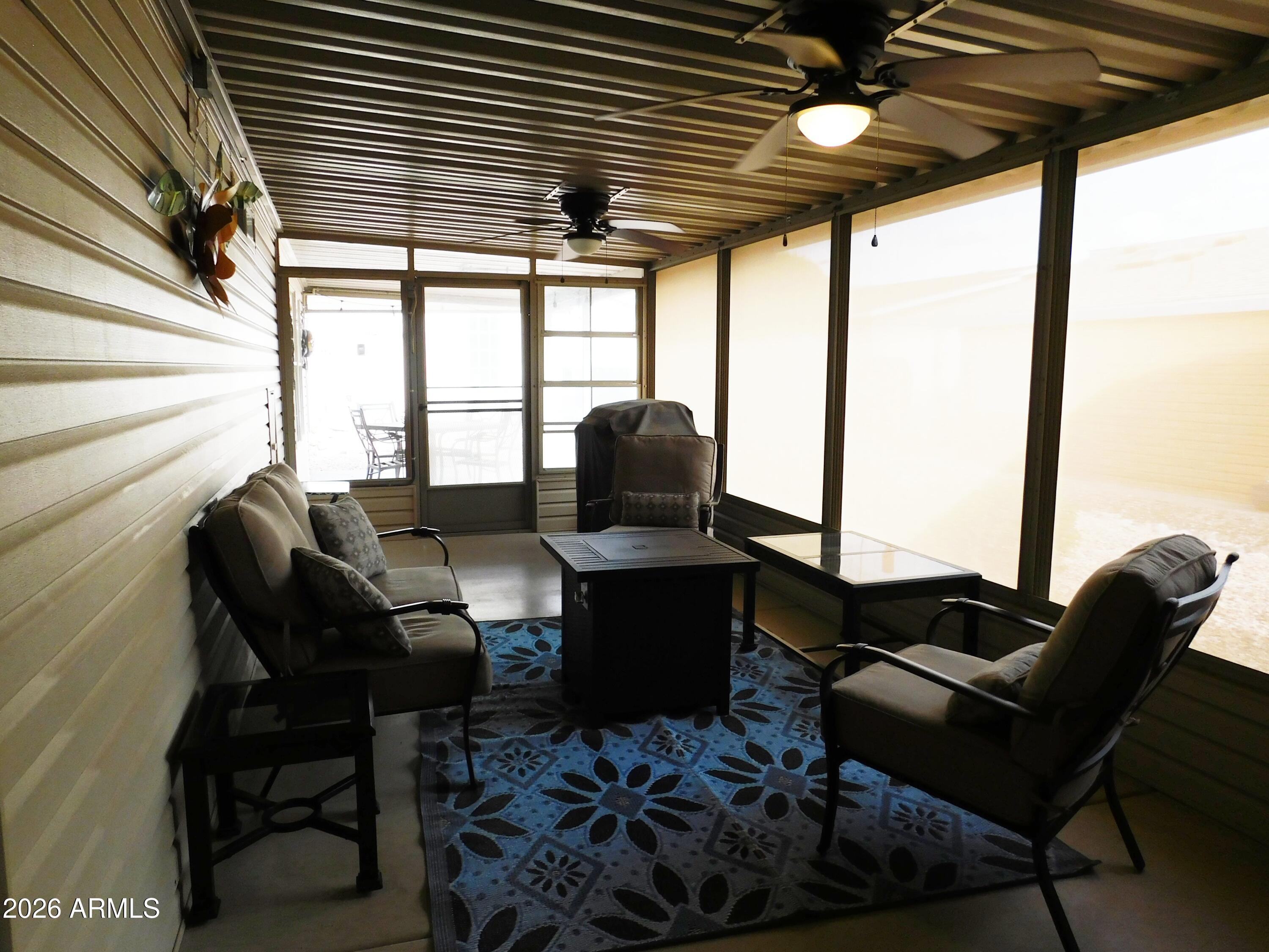 3301 South Goldfield Road, Unit 1054 Apache Junction, AZ 85119 - Photo 31 of 41 a living room with furniture and a large window