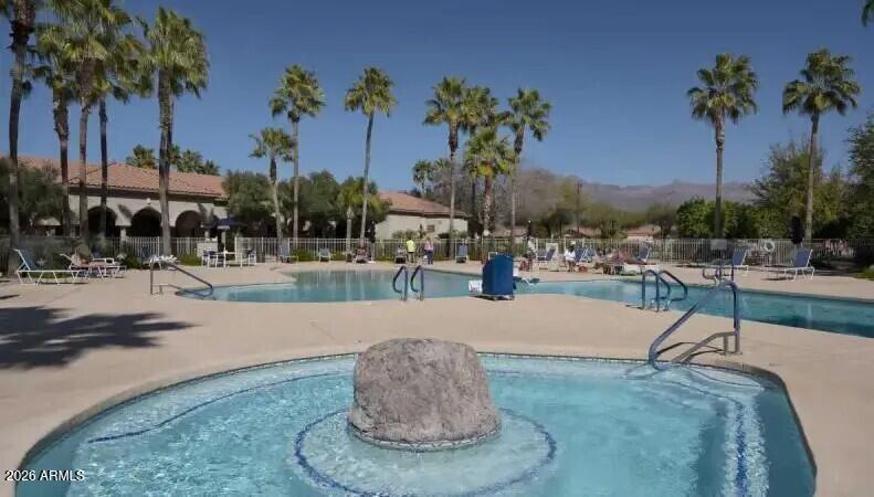 3301 South Goldfield Road, Unit 1054 Apache Junction, AZ 85119 - Photo 35 of 41 a swimming pool with outdoor seating and palm tree