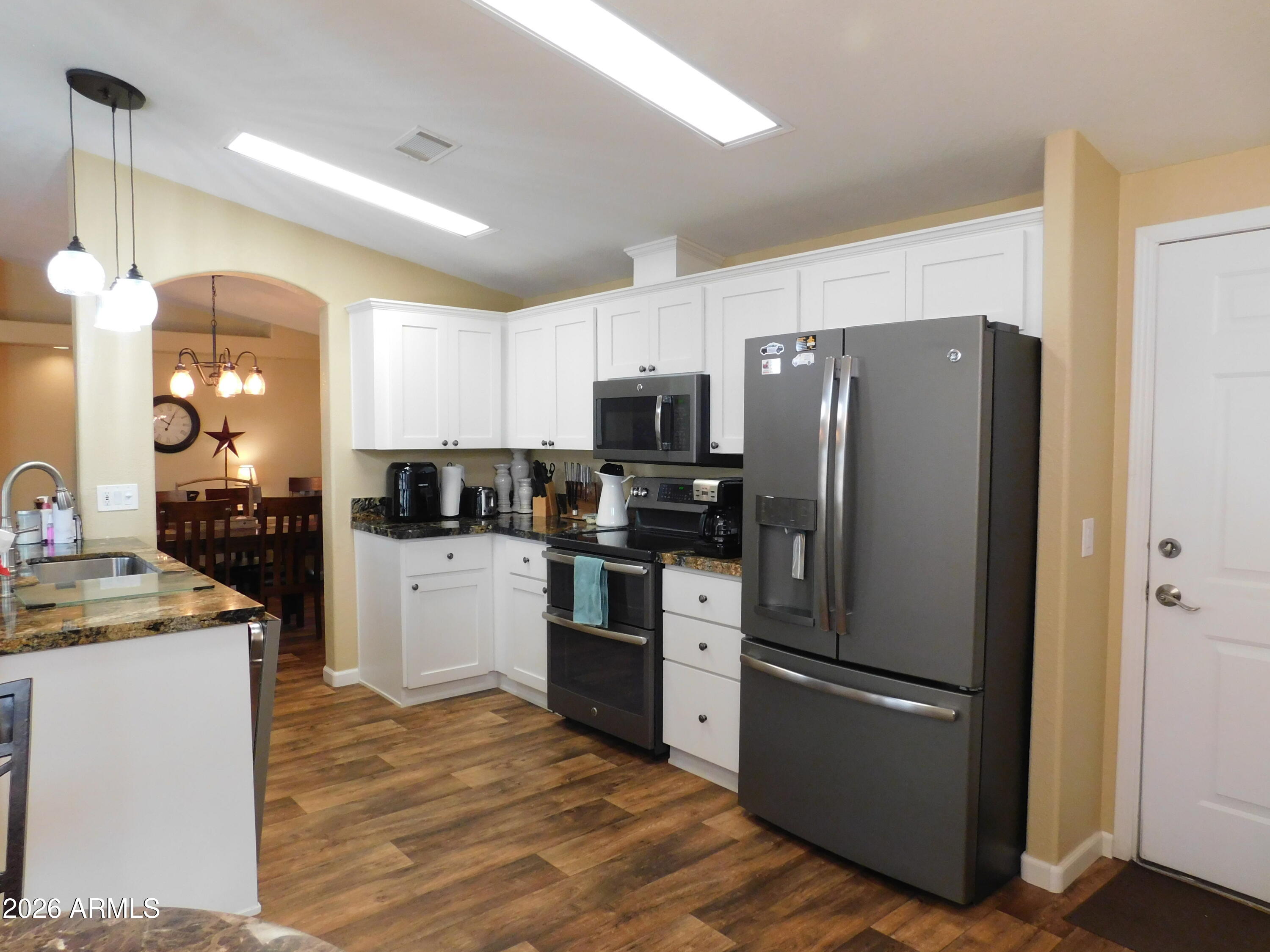 3301 South Goldfield Road, Unit 1054 Apache Junction, AZ 85119 - Photo 4 of 41 a kitchen with a refrigerator a sink and a stove