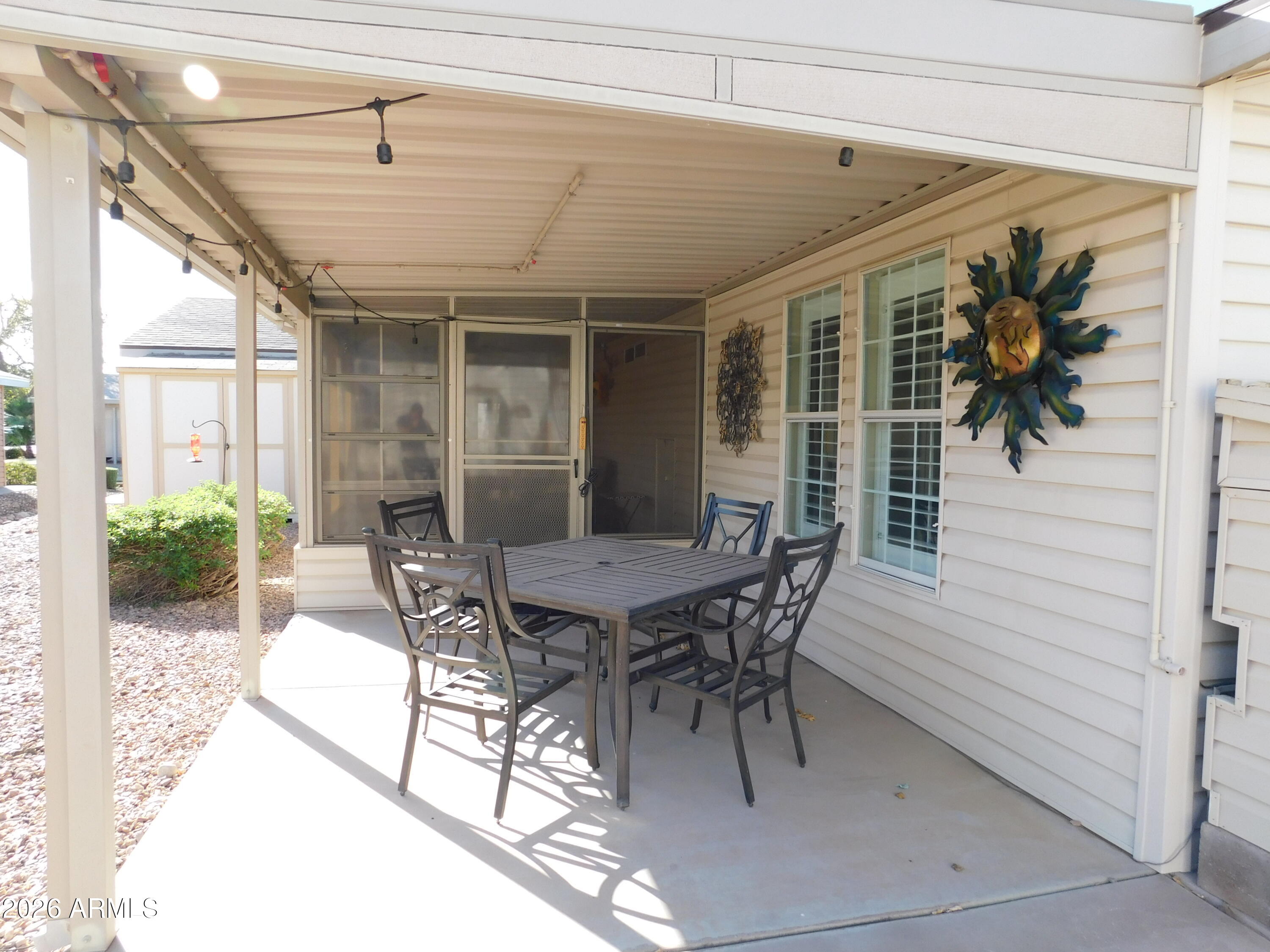 3301 South Goldfield Road, Unit 1054 Apache Junction, AZ 85119 - Photo 9 of 41 a patio with table and chairs and potted plants