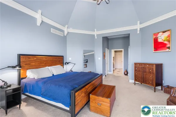 a bedroom with a bed and dresser