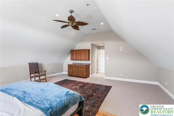 a bedroom with a bed and a dresser in it