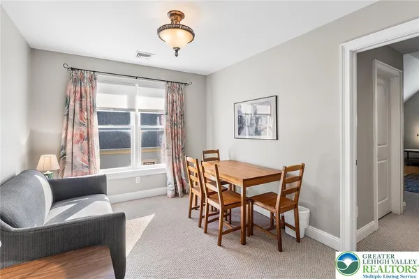 a dining room with furniture and window