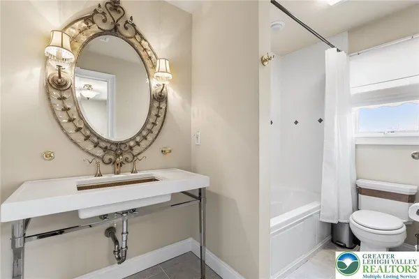 a bathroom with a toilet a sink and a mirror