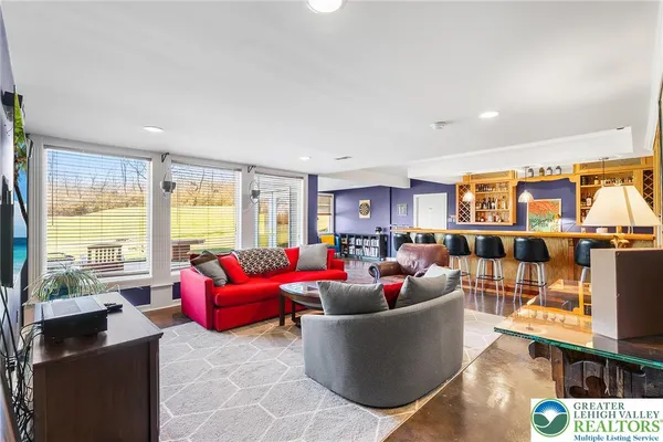 a living room with furniture and a large window