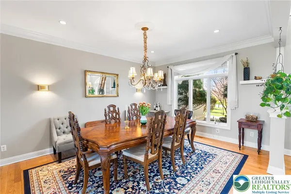 a dining room with furniture a rug and a chandelier