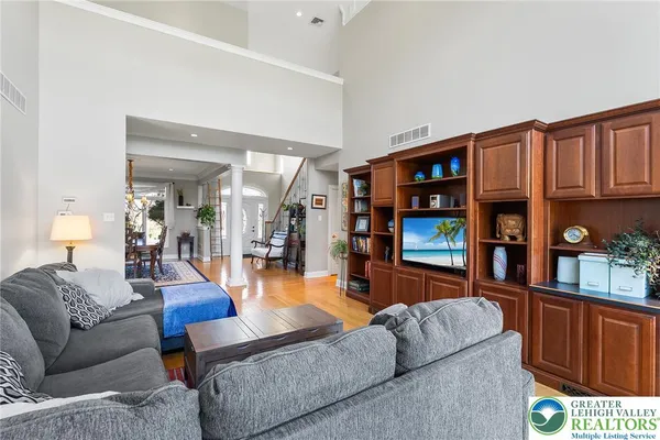 a living room with furniture a wooden floor and bookshelf