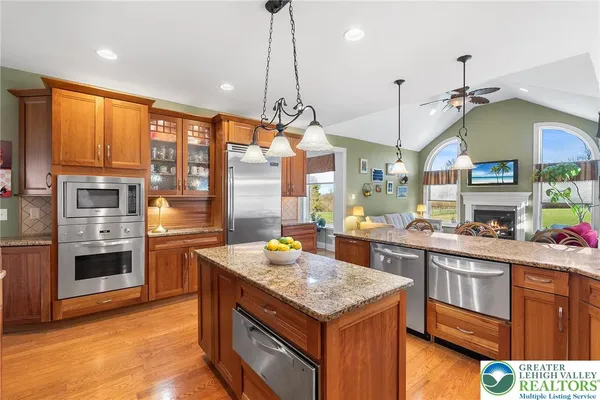 a kitchen with stainless steel appliances granite countertop a stove and refrigerator