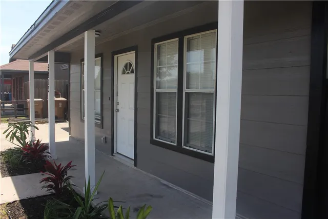 a view of a chandelier fan and fire place