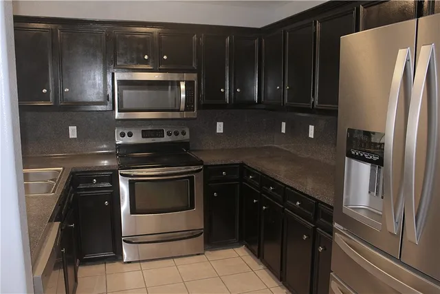 a kitchen with a refrigerator and a sink