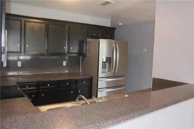a view of a small space with wooden floor and a window