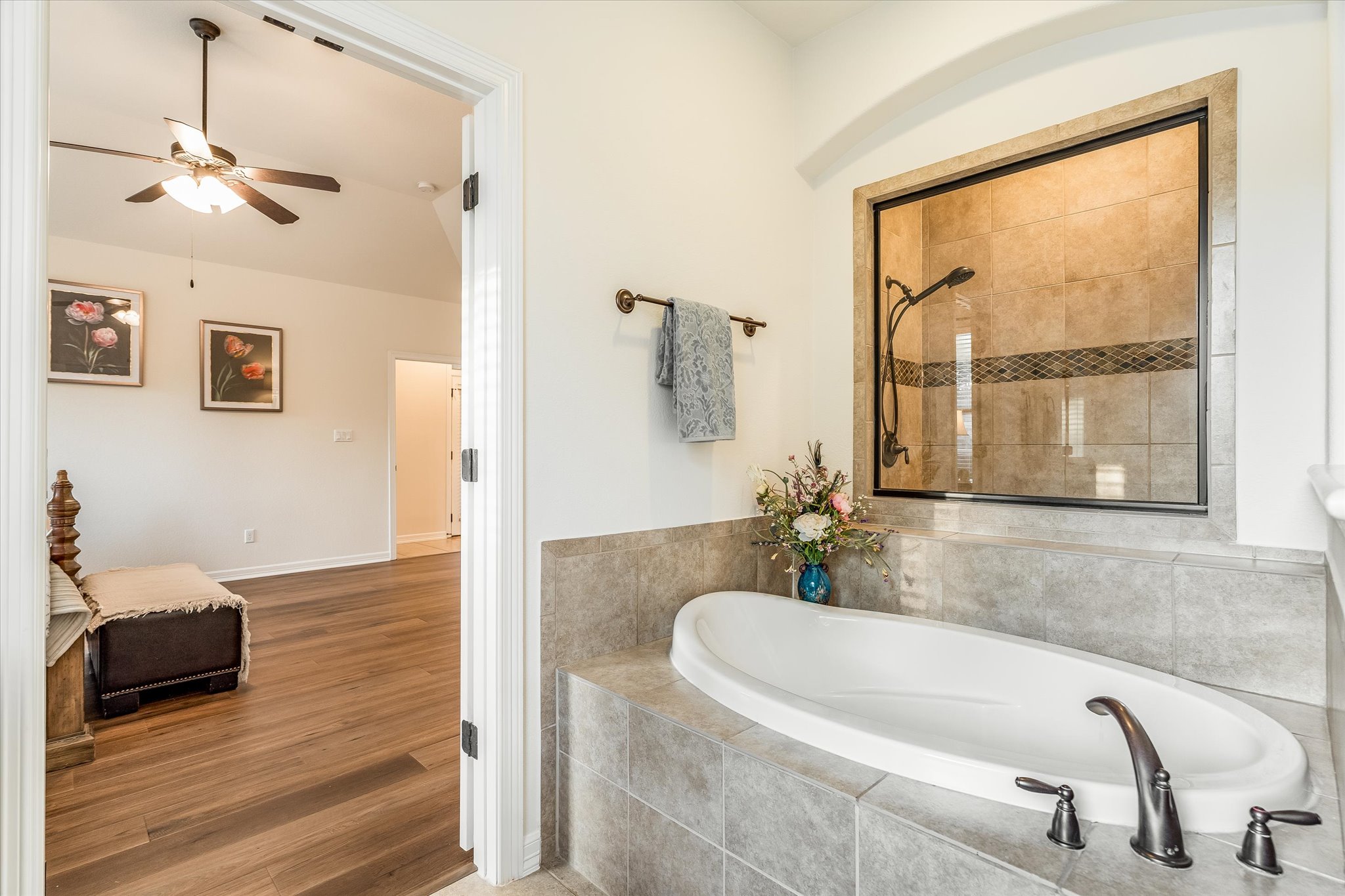 226 Galloway Lane Austin, TX 78737 - Photo 17 of 30 Bathroom with a garden tub, ceiling fan, tiled shower, and wood finished floors