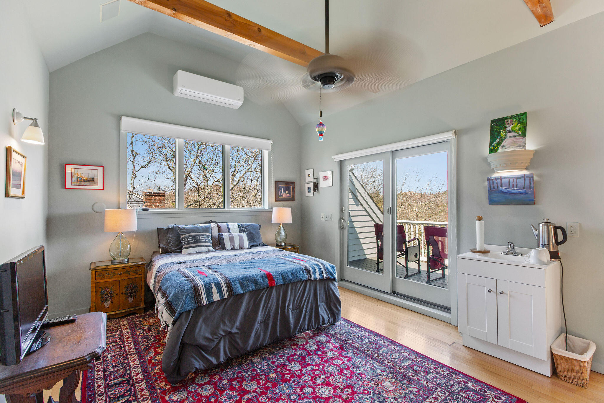 10 Somerset Road Provincetown, MA 02657 - Photo 29 of 50 a bedroom with a bed large window with table and chairs