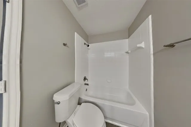 a bathroom with a granite countertop sink and a bathtub