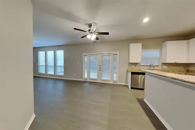 a view of an empty room with window and cabinet