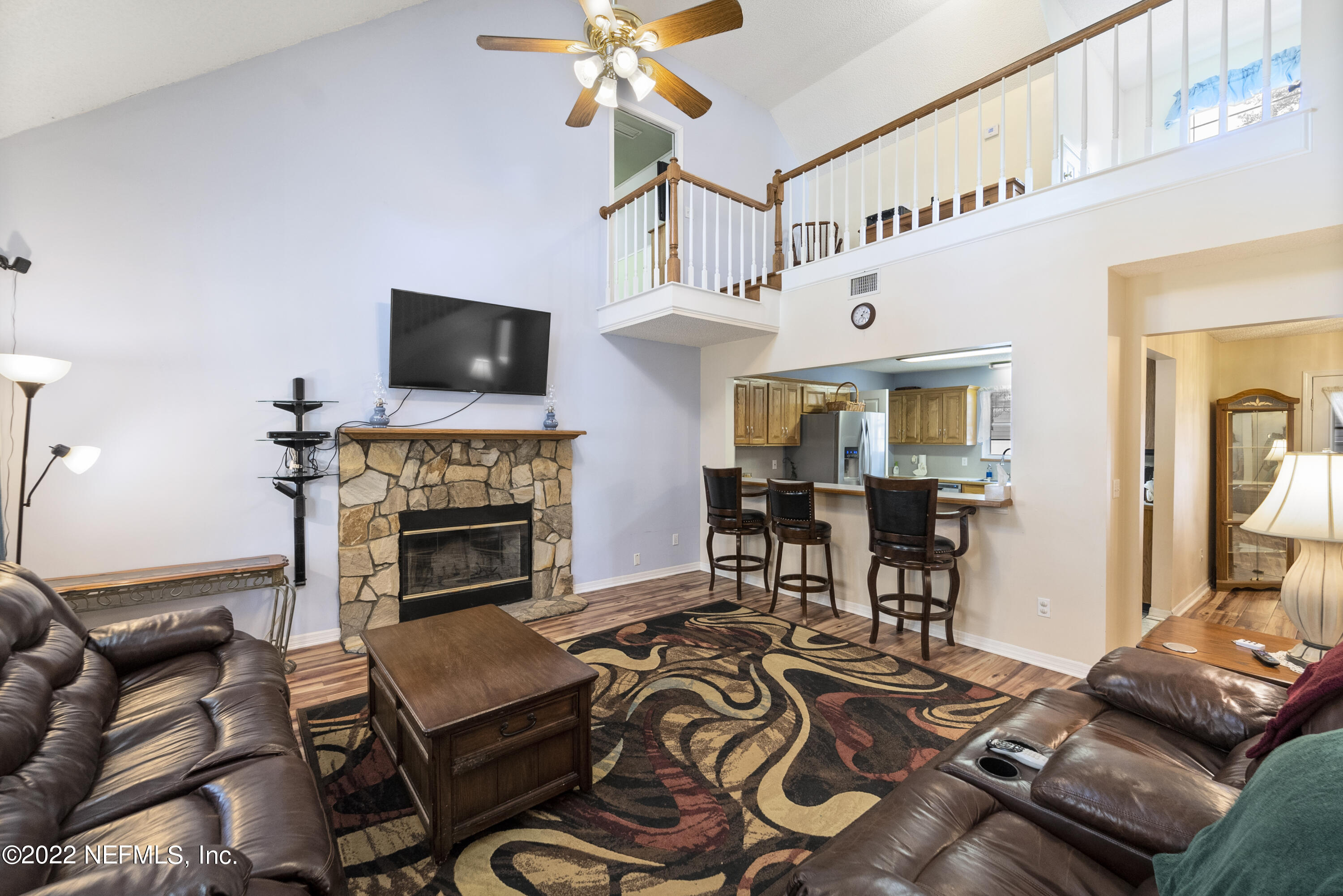 12855 Moose Road Jacksonville, FL 32226 - Photo 12 of 29 a living room with furniture a flat screen tv and a fireplace