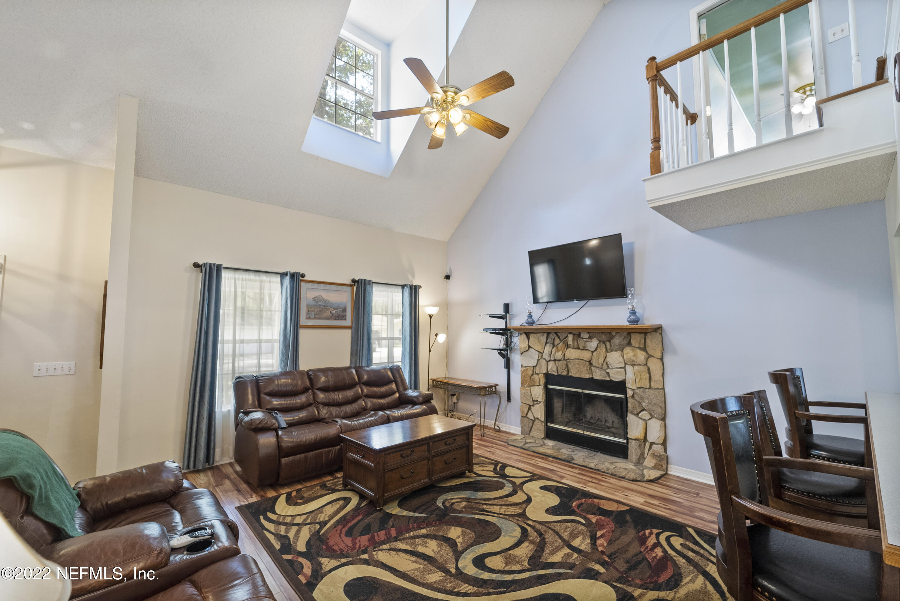 12855 Moose Road Jacksonville, FL 32226 - Photo 13 of 29 a living room with furniture a fireplace and a flat screen tv