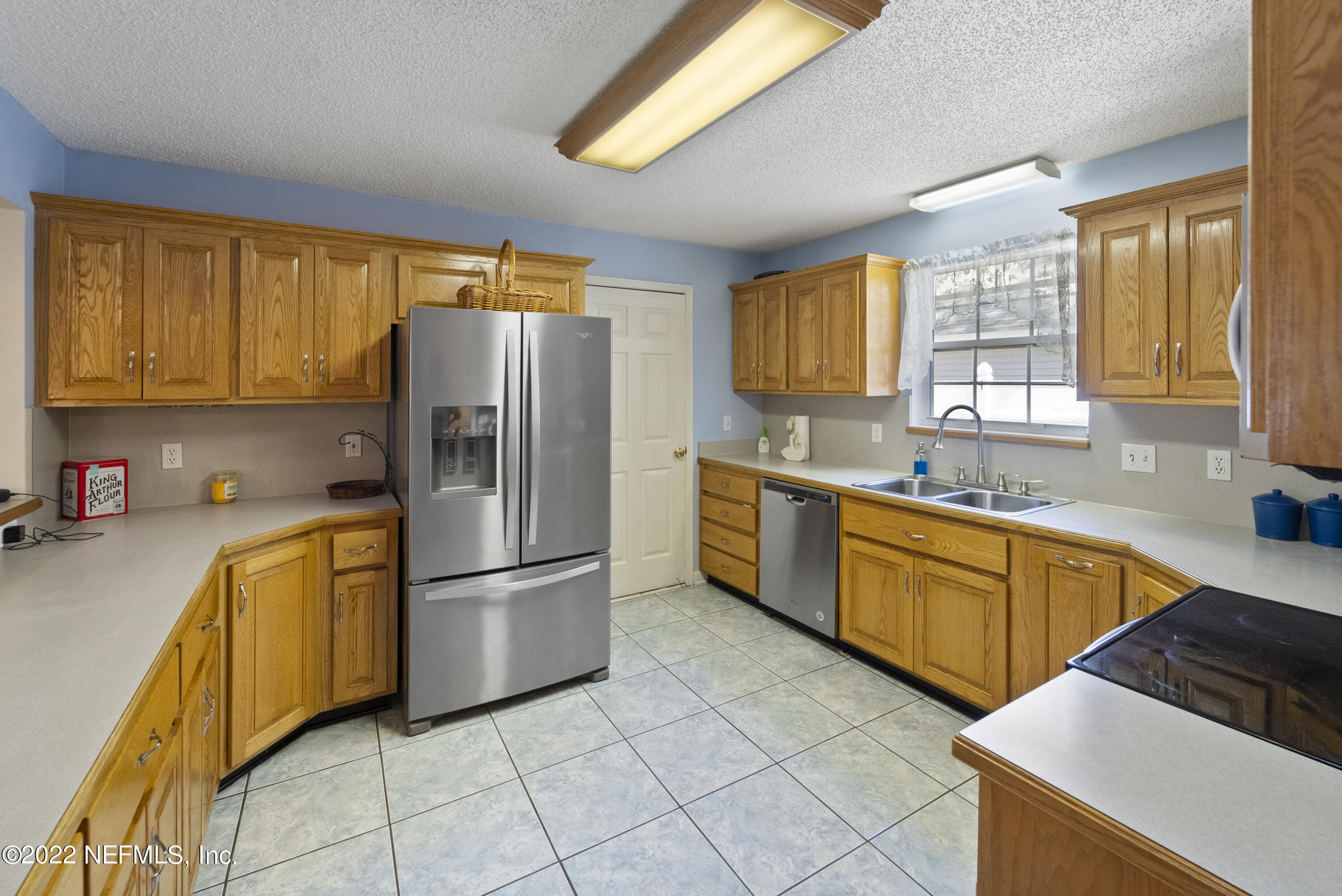 12855 Moose Road Jacksonville, FL 32226 - Photo 14 of 29 a kitchen with stainless steel appliances granite countertop a refrigerator sink and cabinets
