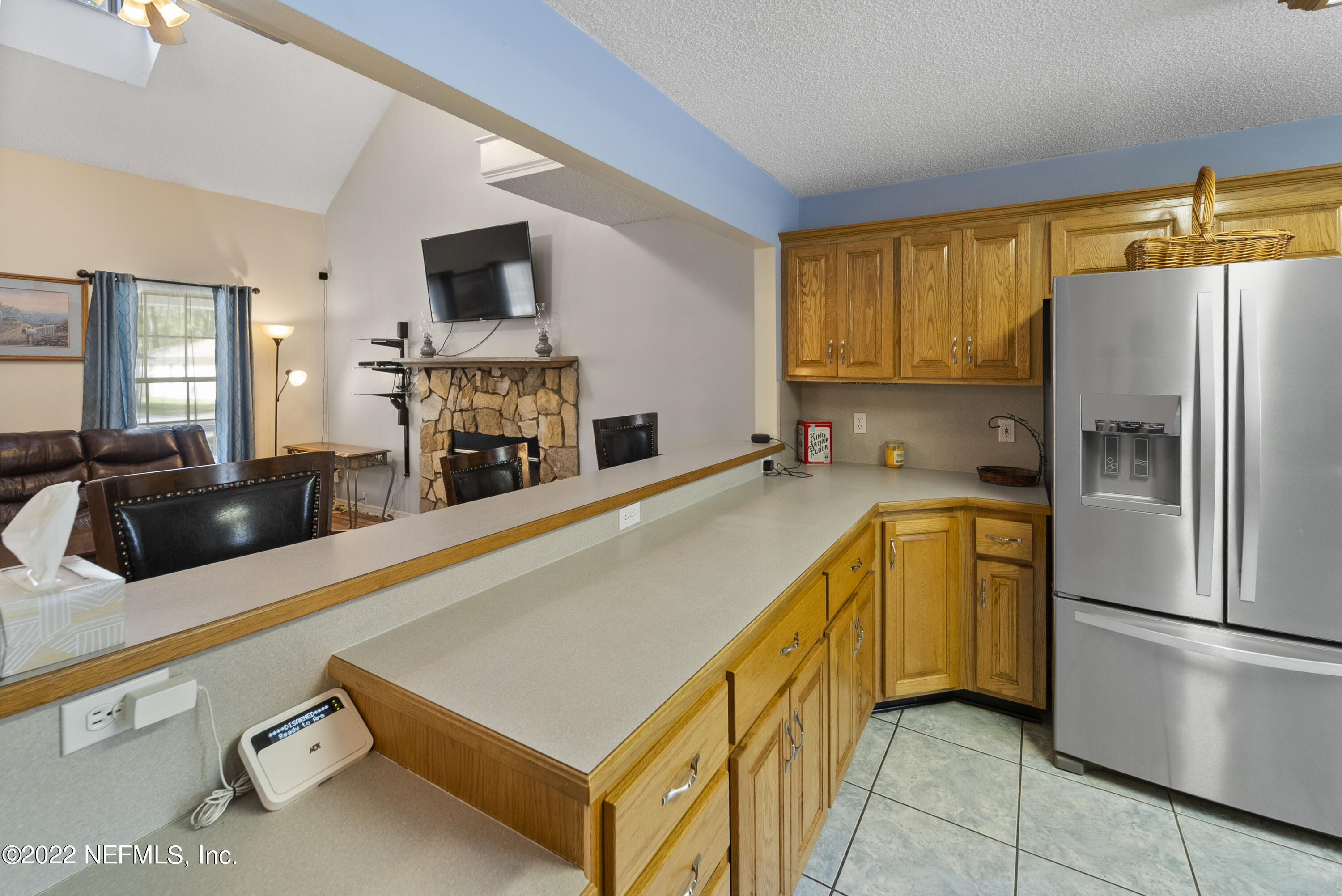 12855 Moose Road Jacksonville, FL 32226 - Photo 15 of 29 a kitchen with stainless steel appliances a refrigerator a stove a sink a dining table and chairs