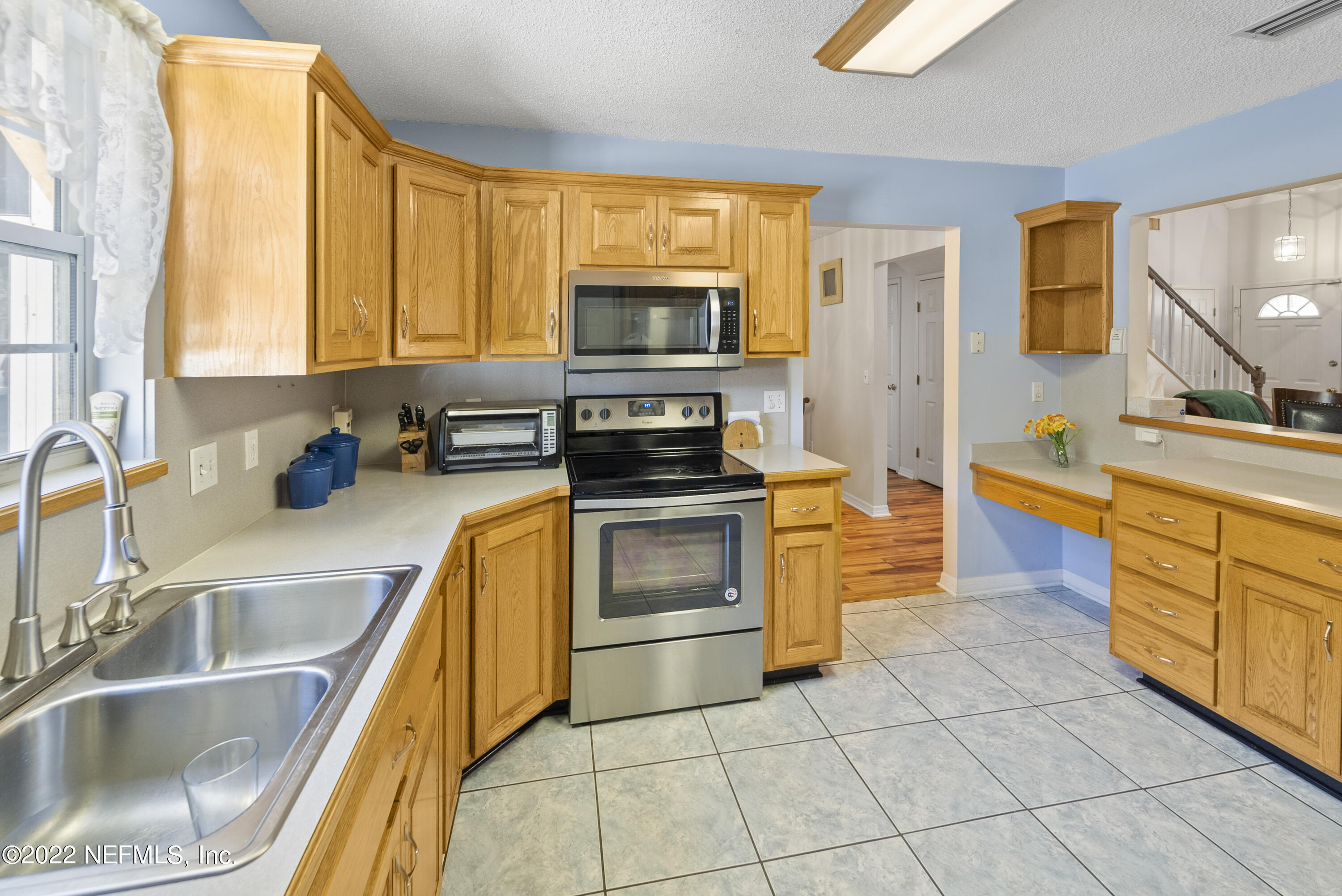 12855 Moose Road Jacksonville, FL 32226 - Photo 17 of 29 a kitchen with stainless steel appliances a stove sink and microwave