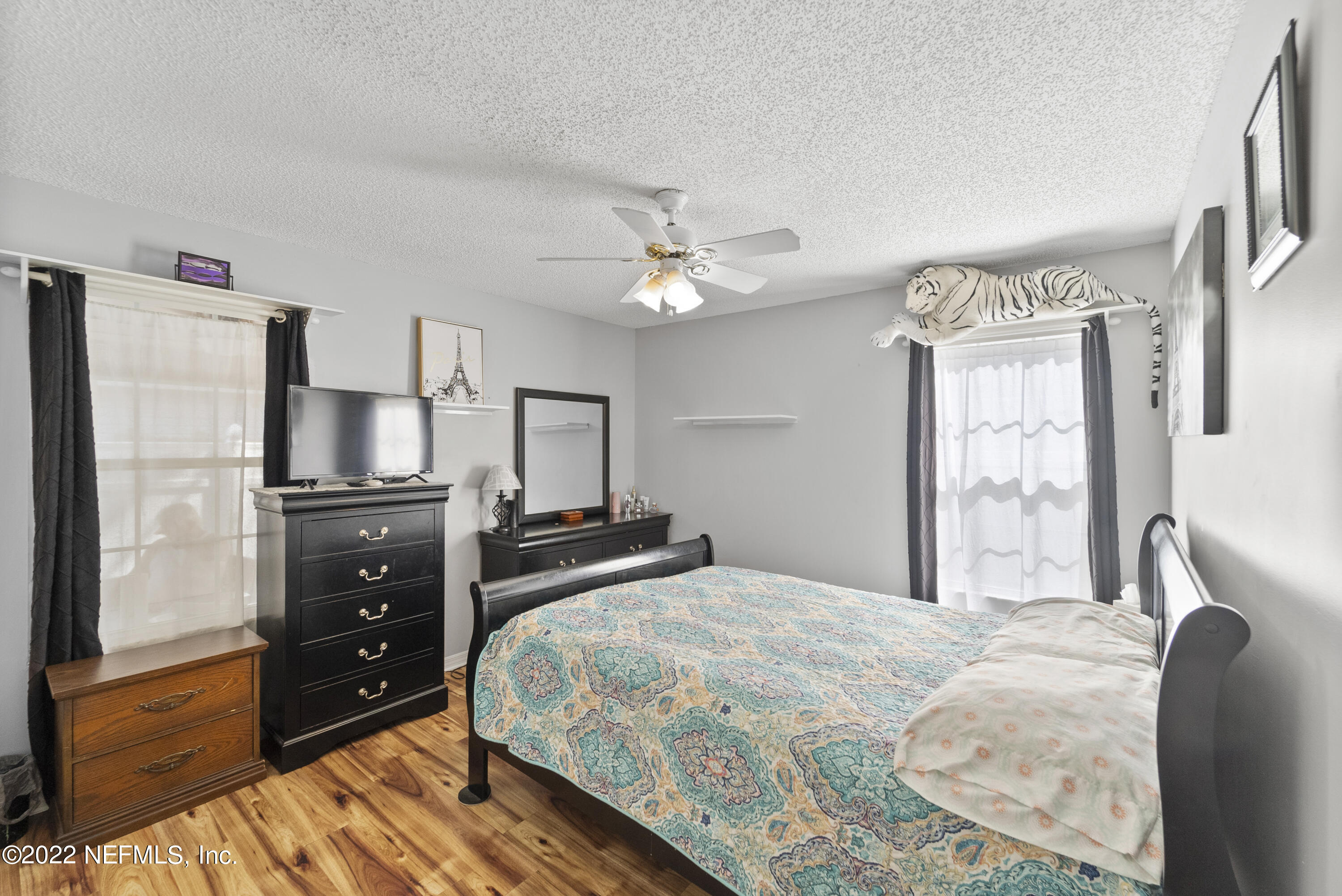 12855 Moose Road Jacksonville, FL 32226 - Photo 20 of 29 a bedroom with a bed a dresser and a flat screen tv