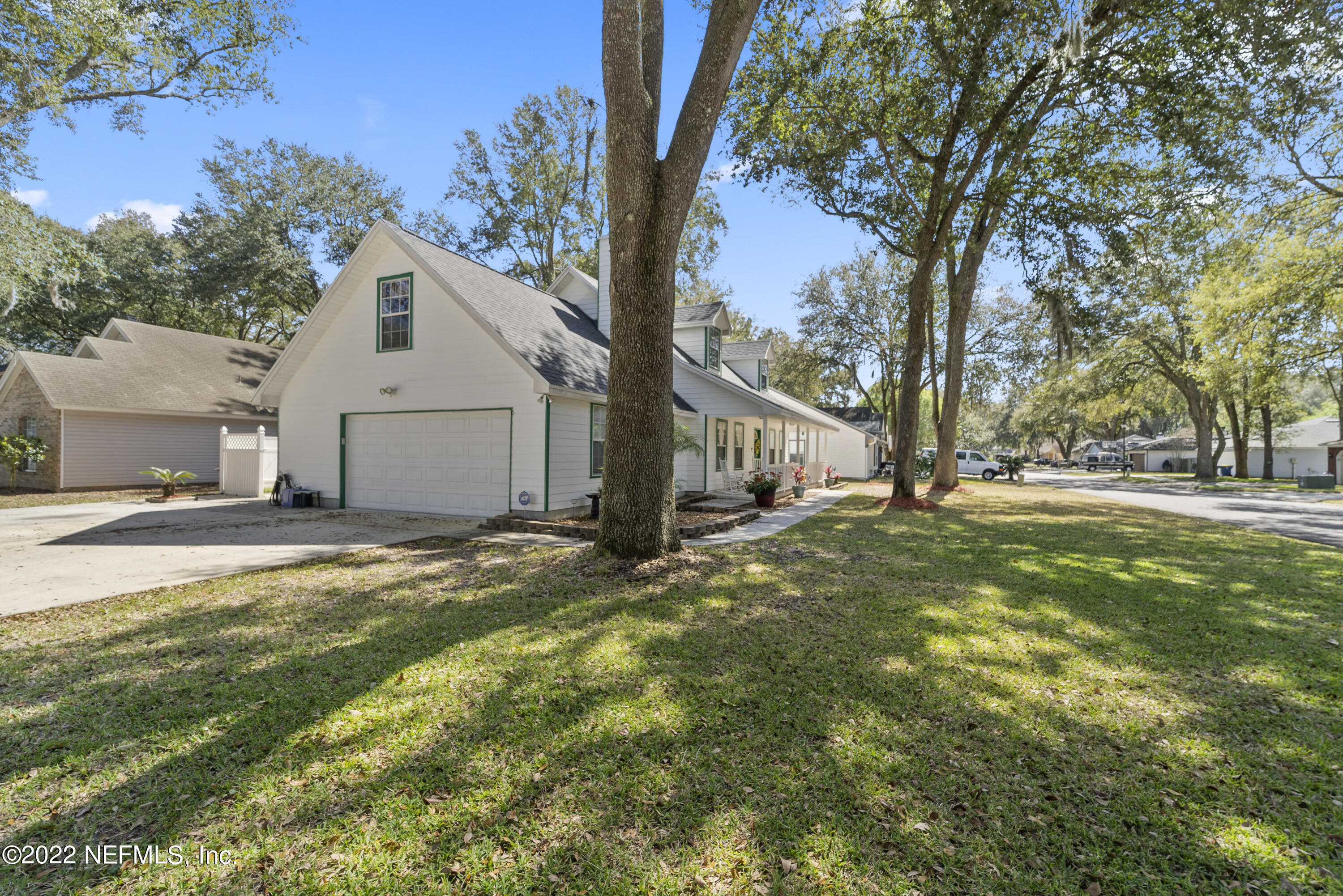 12855 Moose Road Jacksonville, FL 32226 - Photo 6 of 29 a view of a white house next to a road and yard