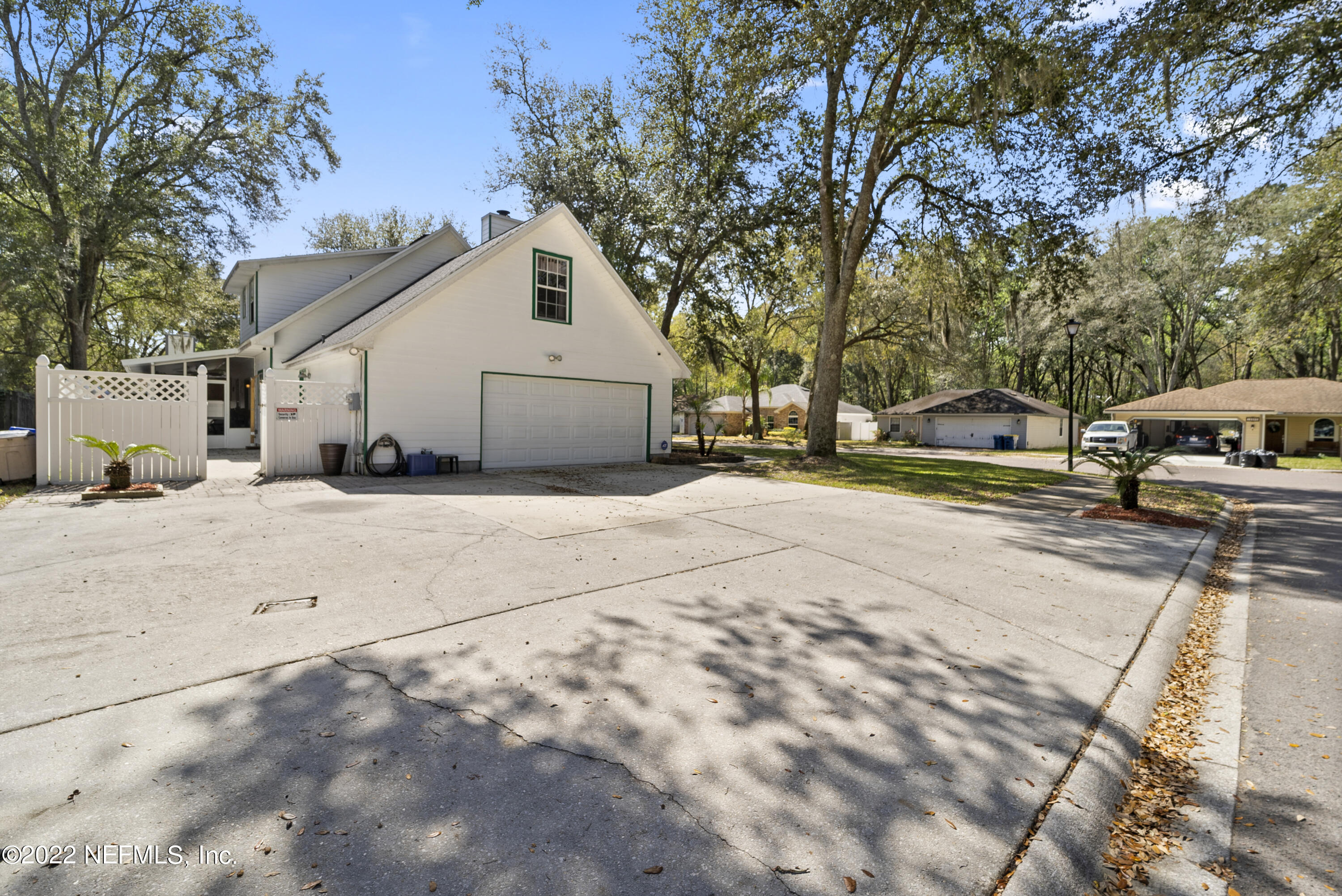 12855 Moose Road Jacksonville, FL 32226 - Photo 7 of 29 a view of a white house with a large tree