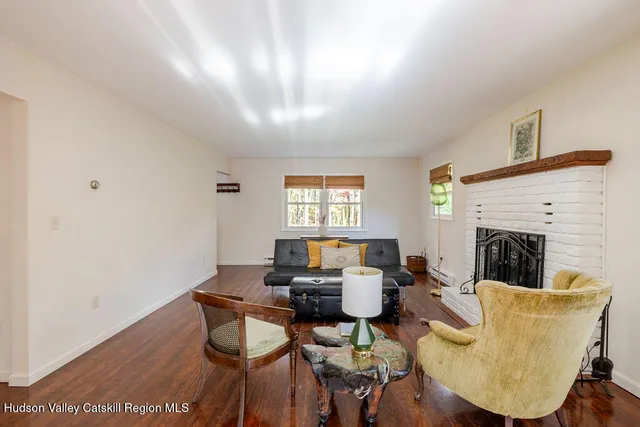 a living room with couches chairs and a fireplace