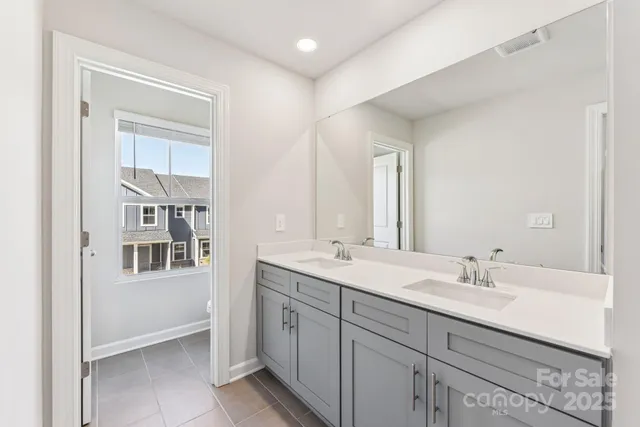 a bathroom with a sink double vanity and a mirror