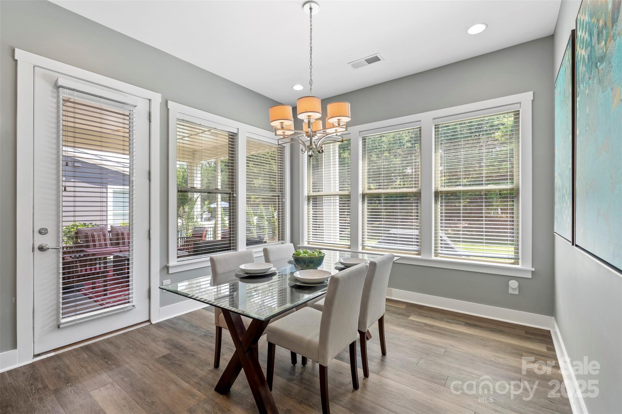 2052 Masons Bend Drive Fort Mill, SC 29708 - Photo 16 of 41 a view of a dining room with furniture large windows and wooden floor