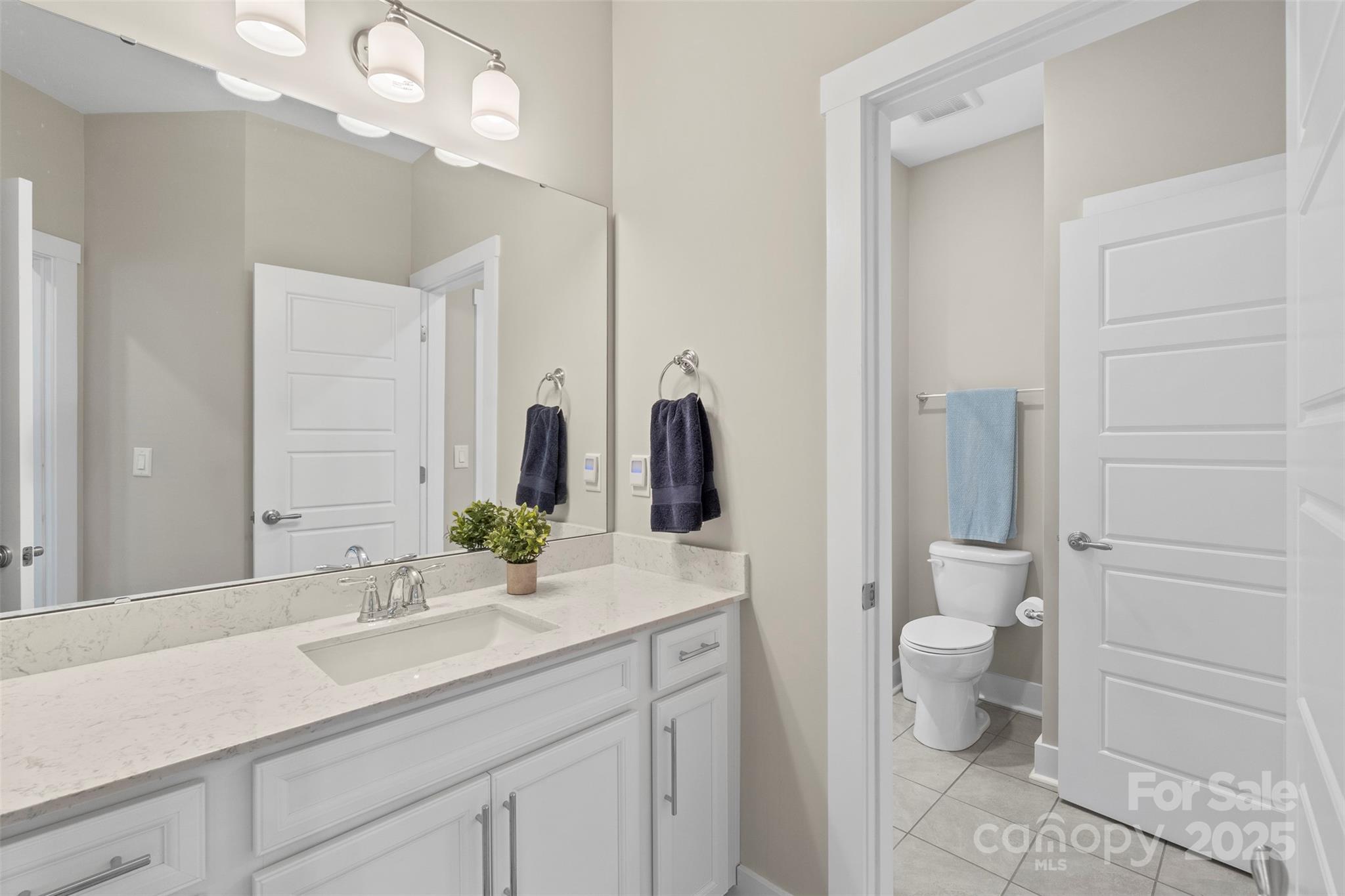 2052 Masons Bend Drive Fort Mill, SC 29708 - Photo 28 of 41 a bathroom with a sink a toilet and large mirror