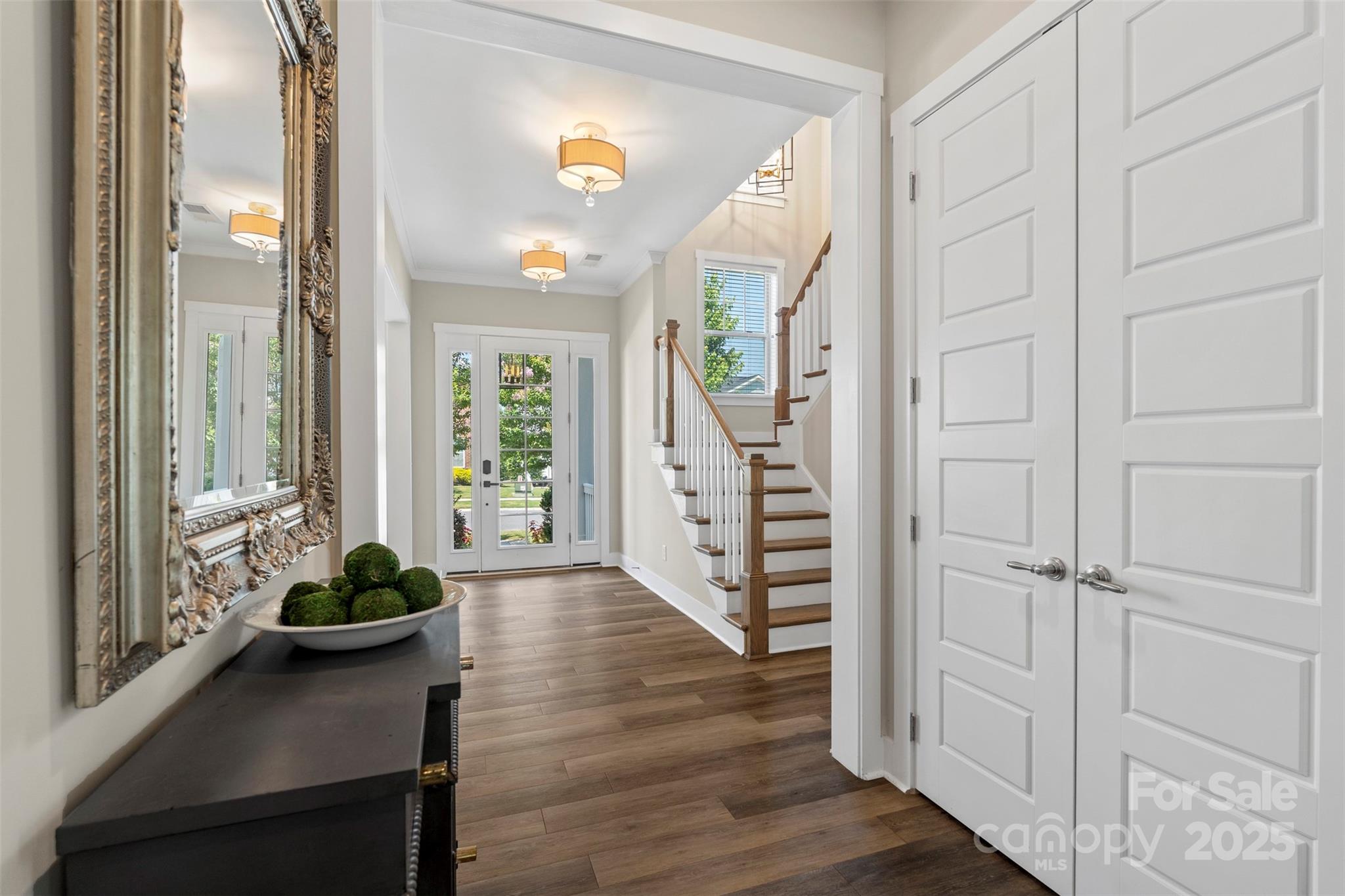 2052 Masons Bend Drive Fort Mill, SC 29708 - Photo 7 of 41 a hallway with wooden floor windows and stairs