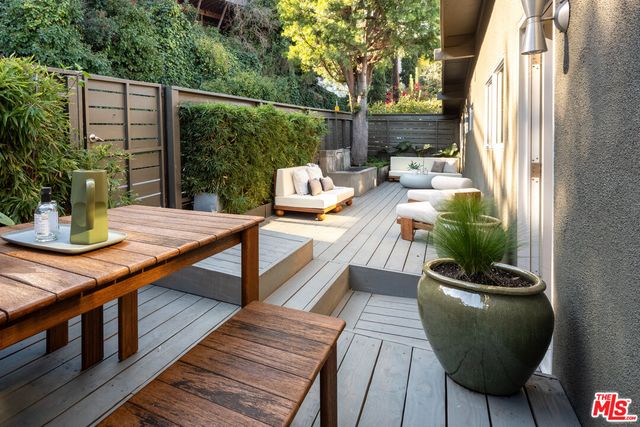 a view of balcony with wooden floor and seating space