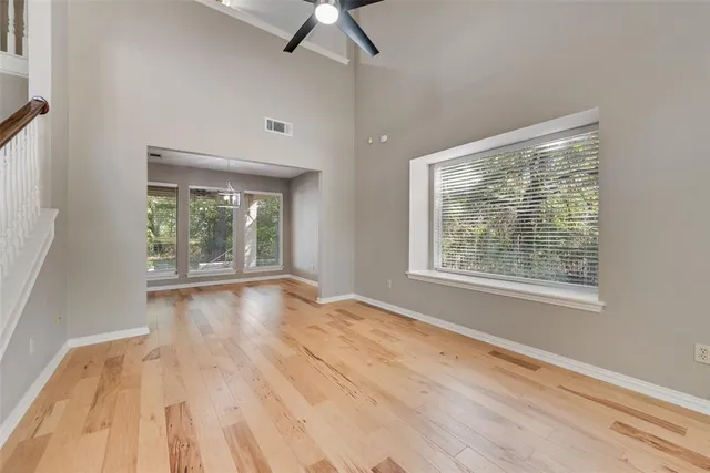 a view of empty room with fireplace and window