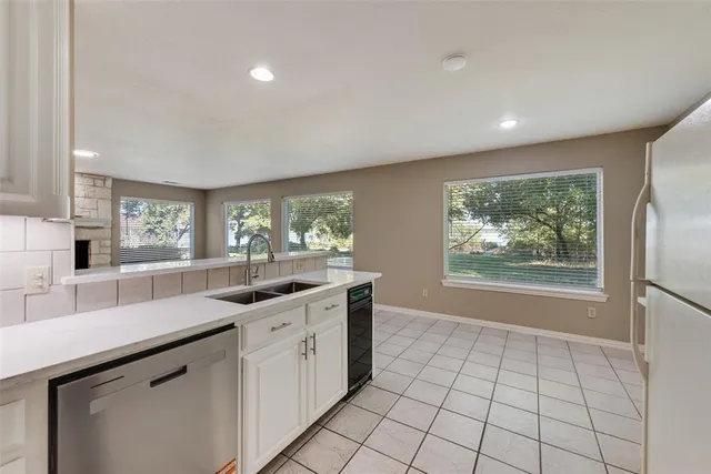 an empty room with windows and ceiling fan view