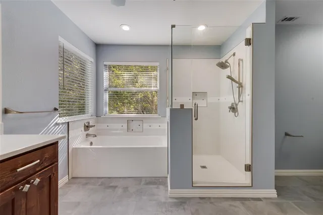 a spacious bathroom with a sink and a large mirror