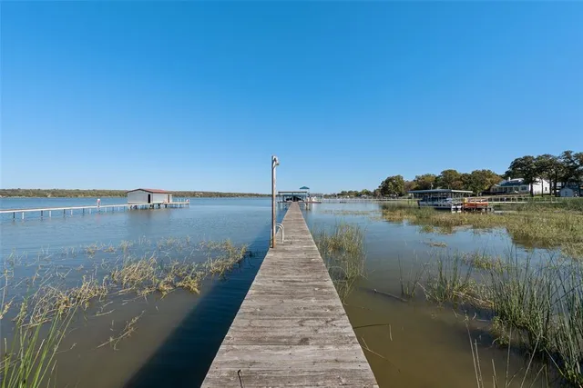 a view of a patio with chairs and umbrellas on a table