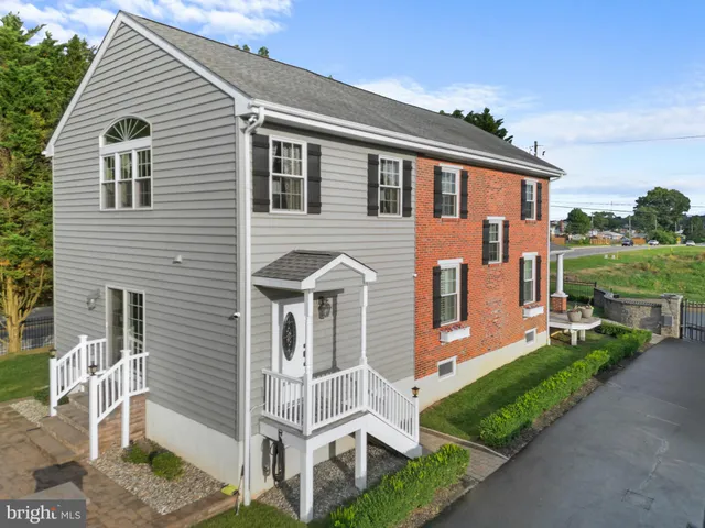 a front view of house with a garden and patio