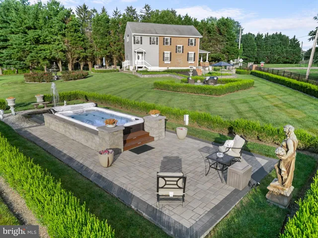 a view of a backyard with a garden and entertaining space