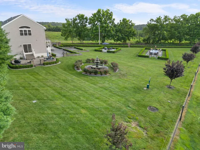 an aerial view of a tennis ground and a houses view