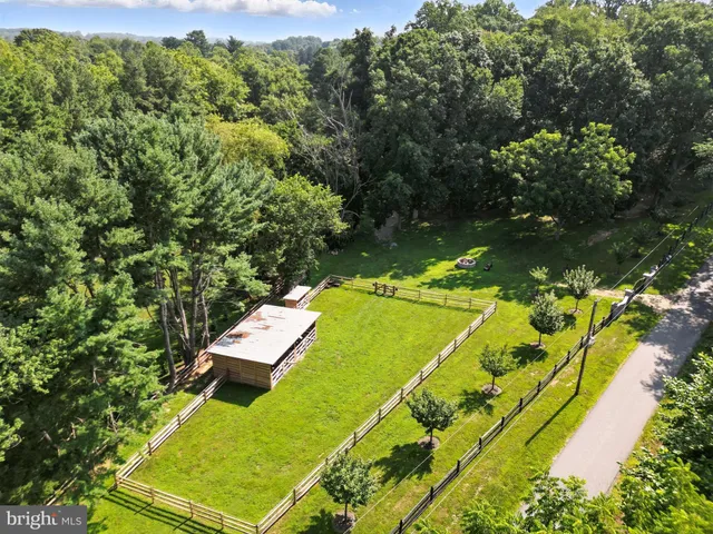 a dining room with furniture a large window and wooden floor