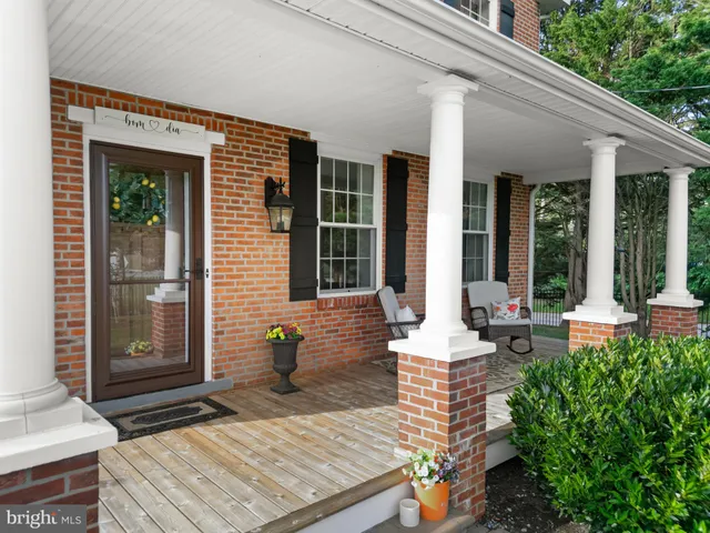 a kitchen with a refrigerator a stove a sink and a dining table with wooden floor