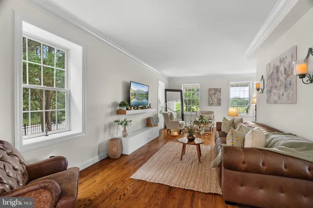 a view of a hallway with dining area wooden floor and a livingroom view